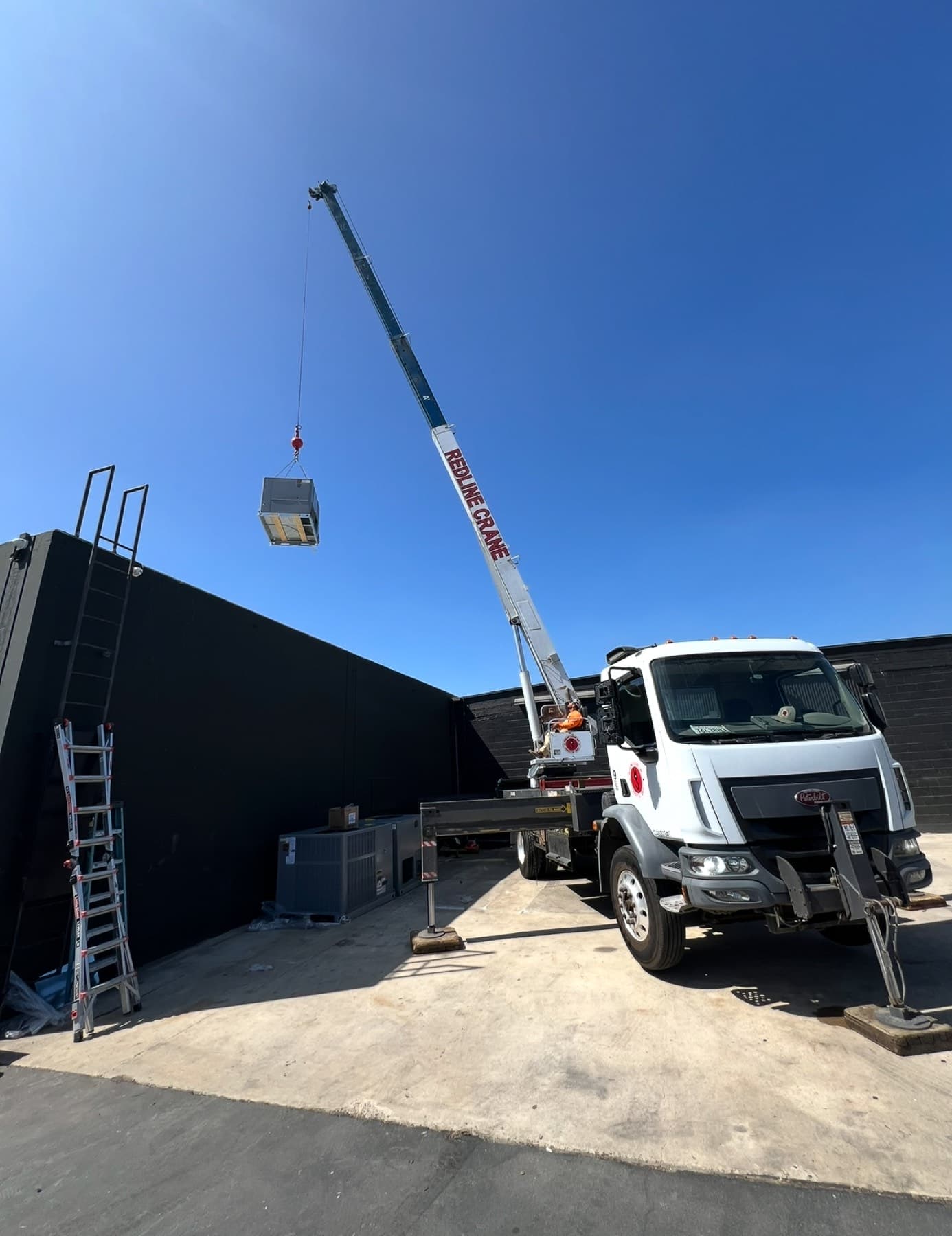 Service truck and crane staged for a same-day set