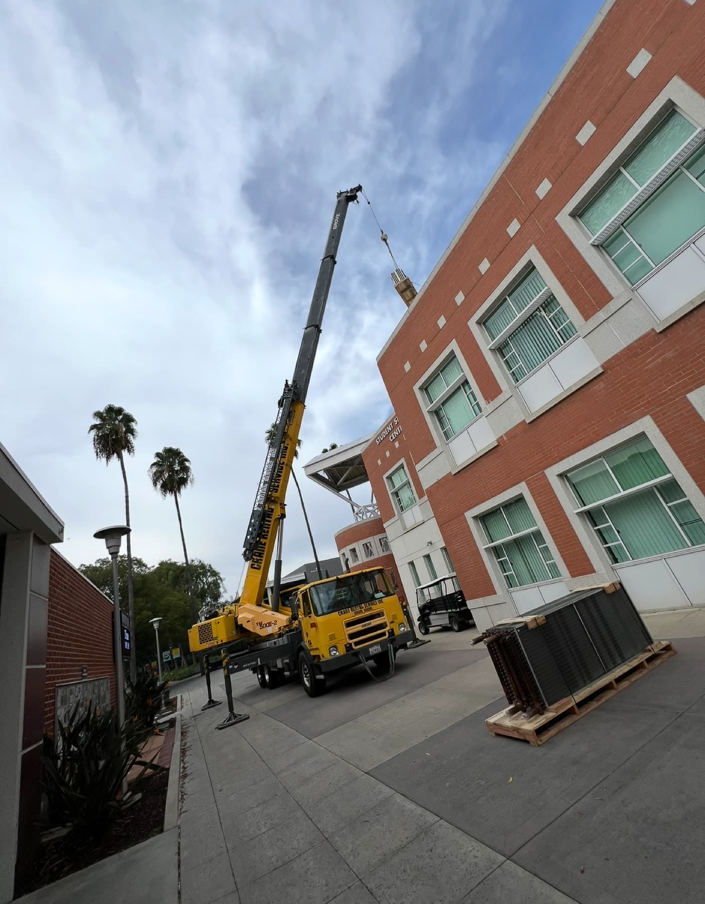 Street-side crane staging for a downtown change-out